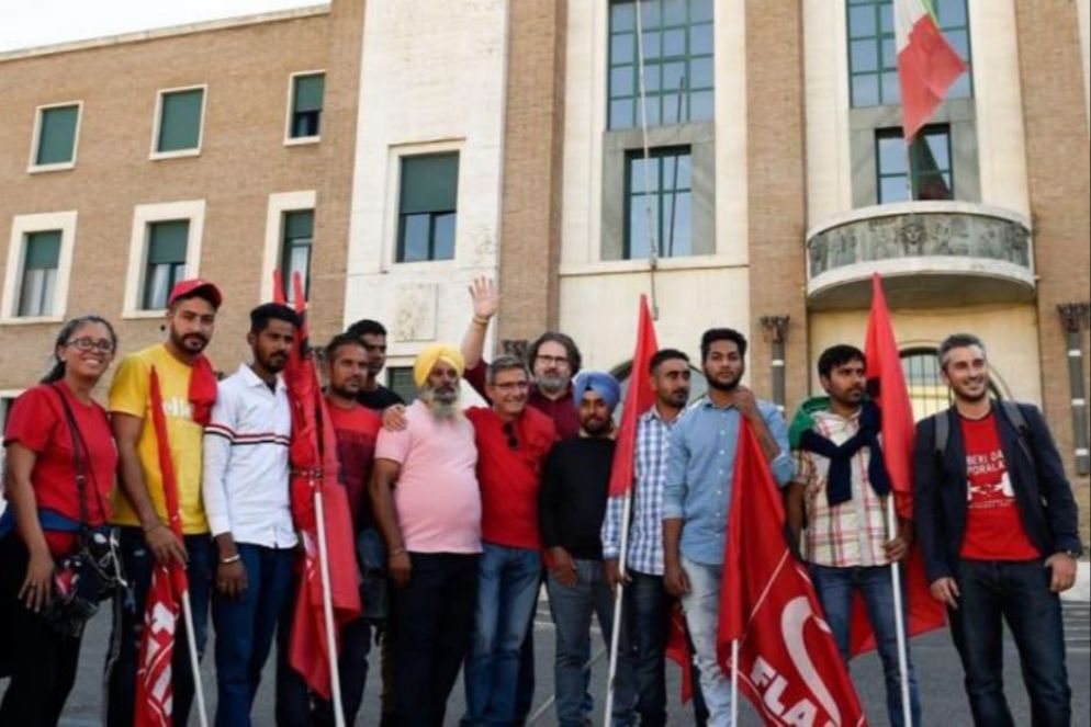 Il sociologo Omizzolo (con la mano alzata) tra i braccianti di Latina - Dal Web